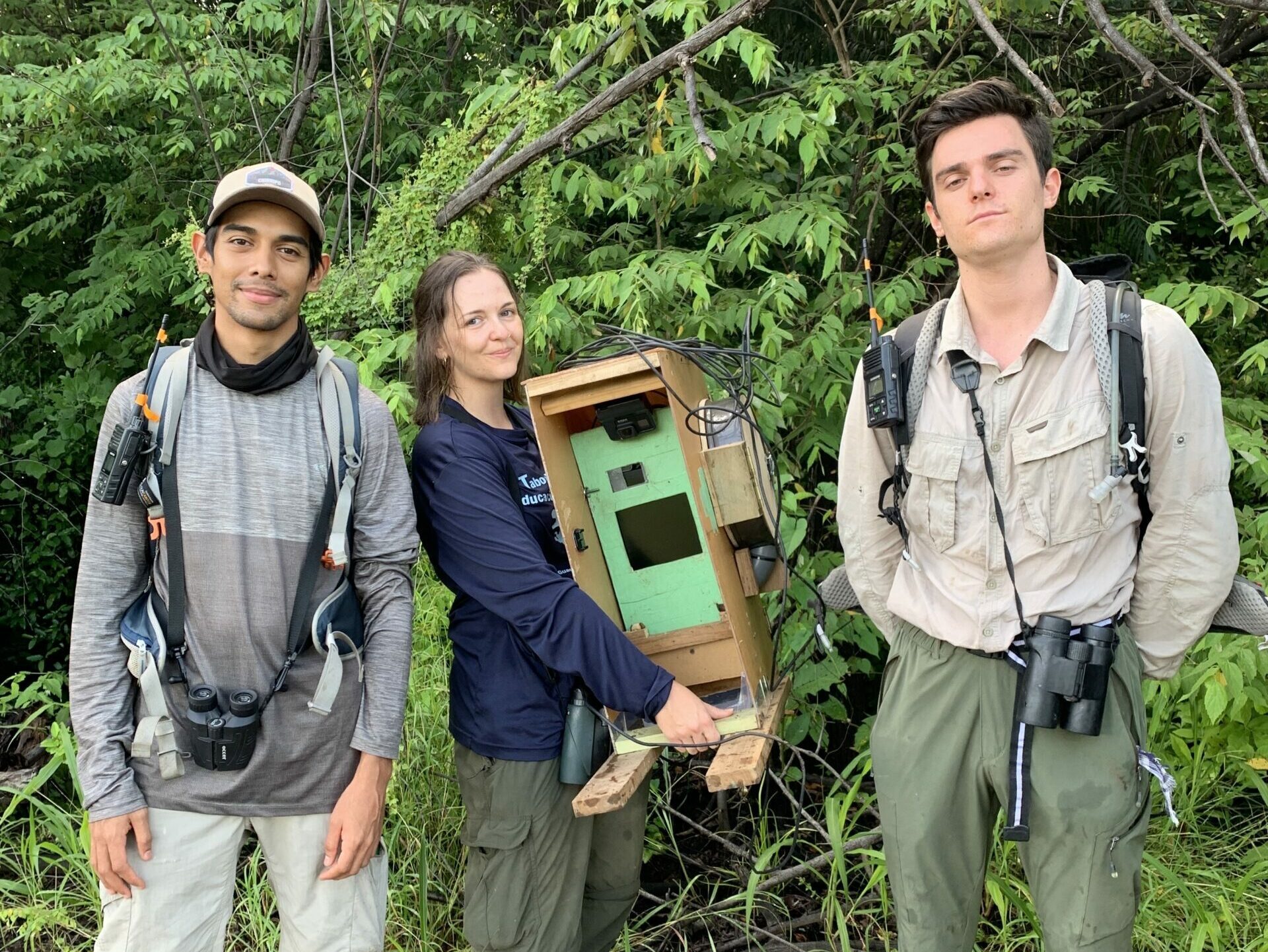 Photo of team members holding field equipment